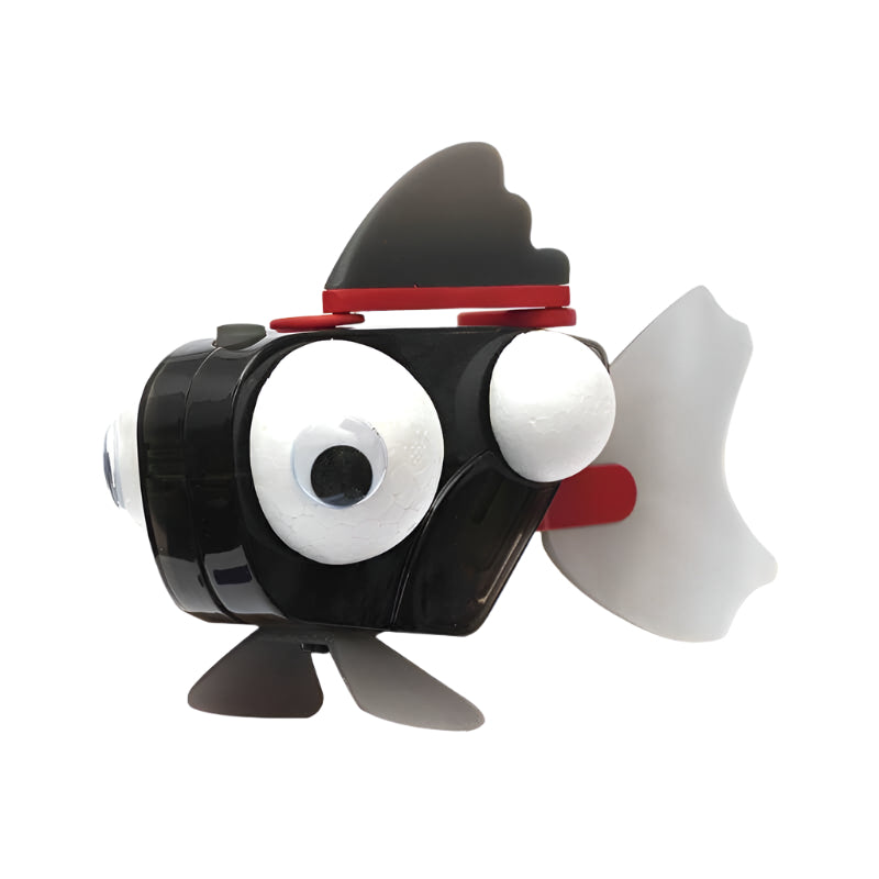 Black and white robotic fish toy with large eyes, fin, and tail made from recycled materials for ocean conservation education