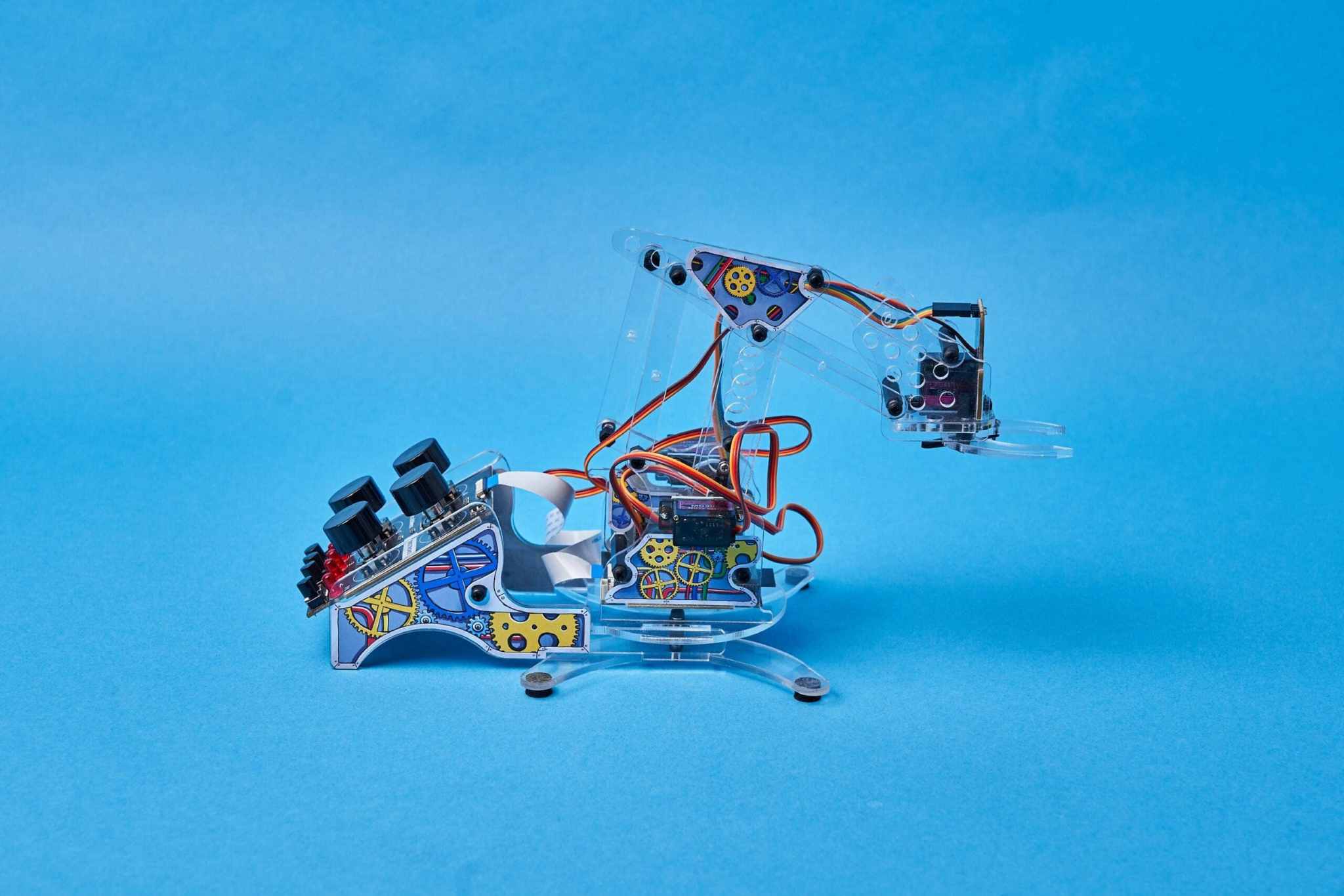 DIY color detecting Armstrong programmable robotic arm kit with sensors and servo motors on blue background