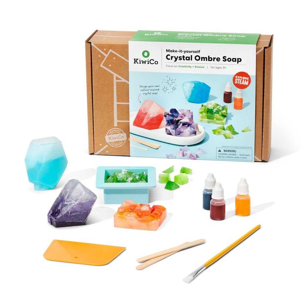 Crystal Geode Soapmaking Kit with molds, liquid colors, mica powder, craft sticks, and instructions for DIY ombre crystal soaps.