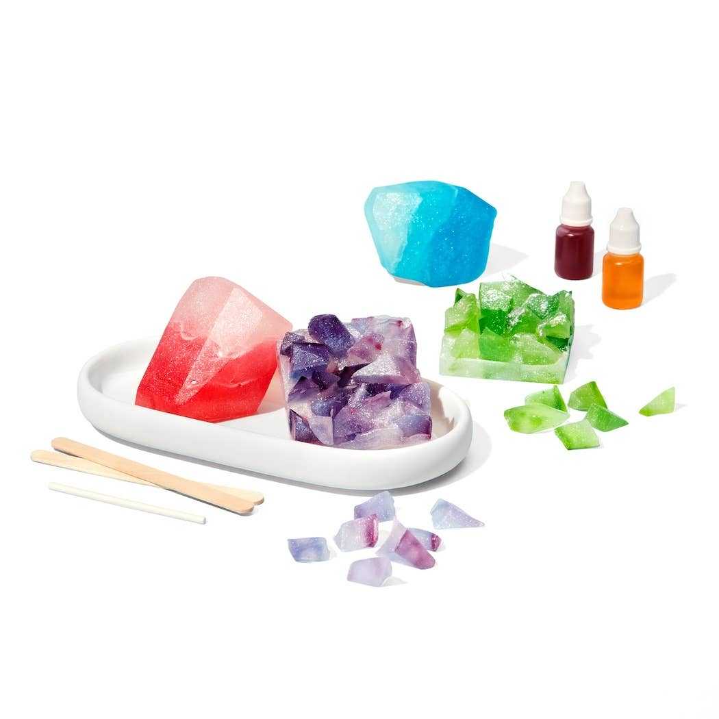 DIY Crystal Geode Soapmaking Kit with colorful soap pieces, silicone molds, liquid colors, and craft sticks for kids