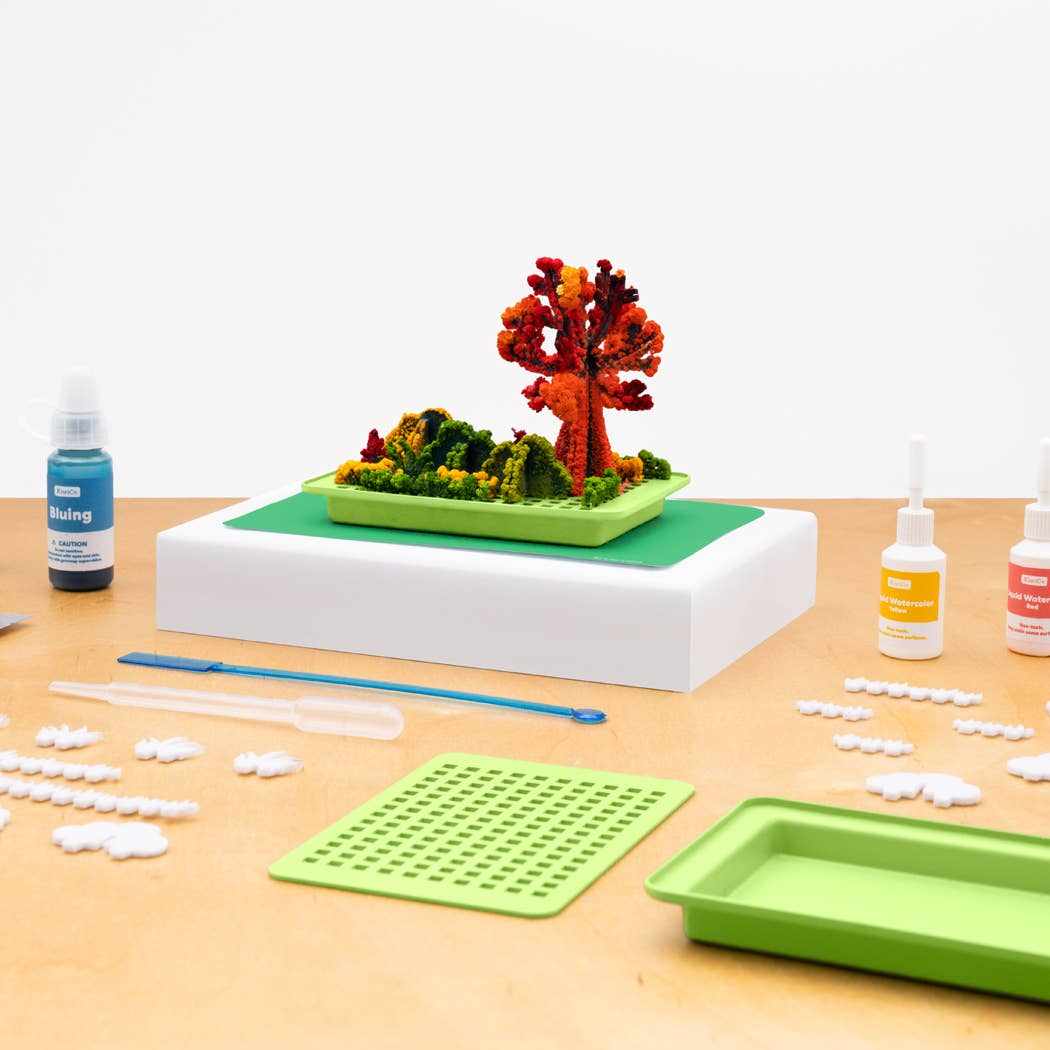 Crystal Chemistry Garden kids chemistry toy with colorful crystal trees and bushes kit on table with blue bluing bottle and pipette
