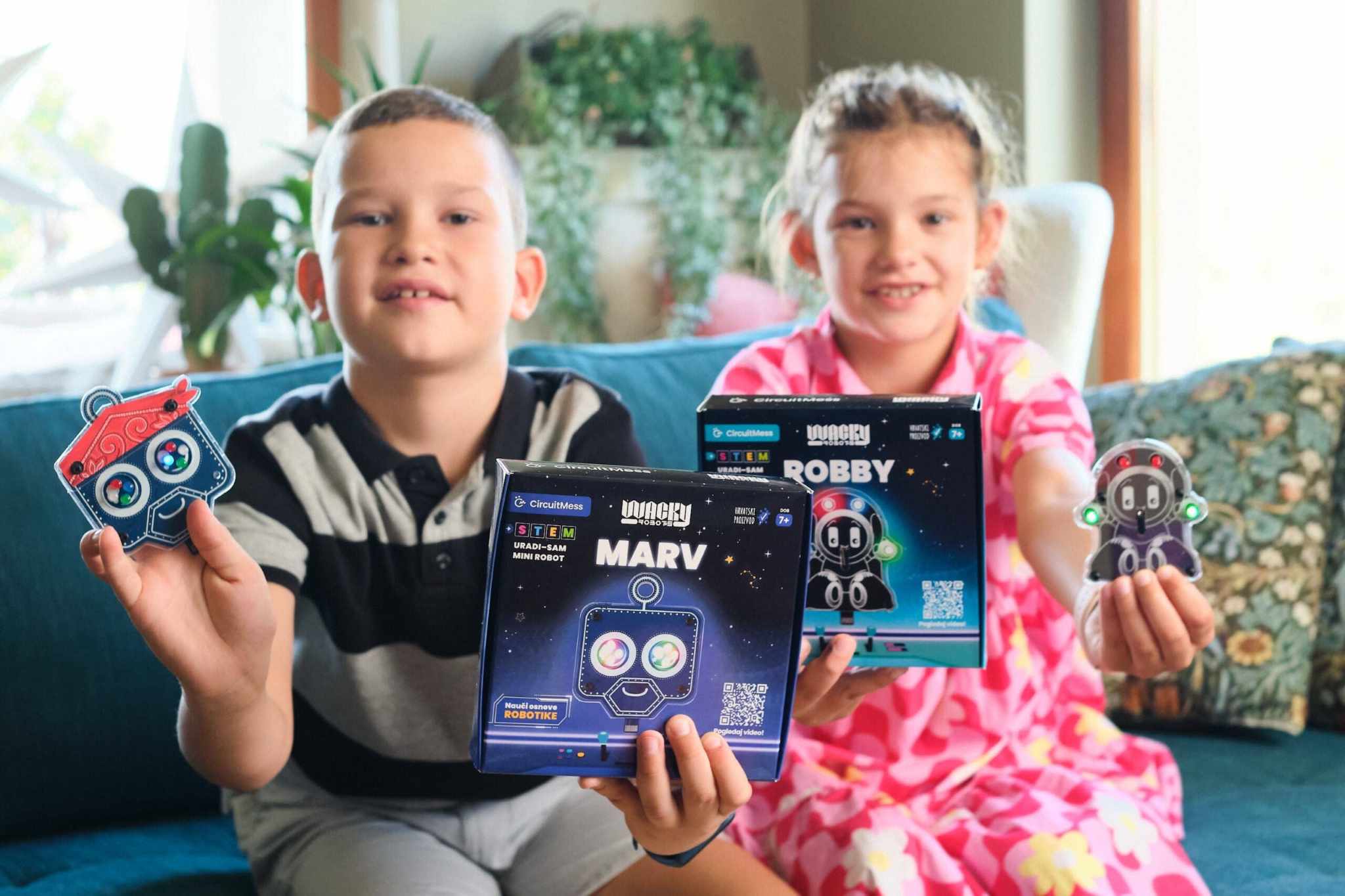 Children holding Wacky Robot Robby and Marv STEM mini robot kits from CircuitMess collection