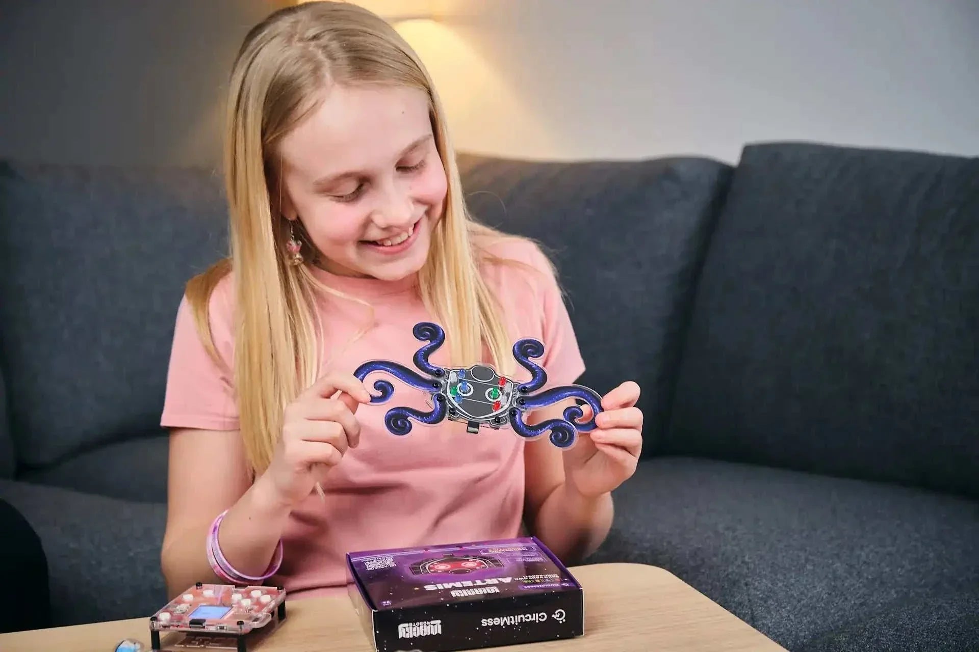 Girl holding assembled Wacky Robot Artemis mini robot from DIY STEM kit