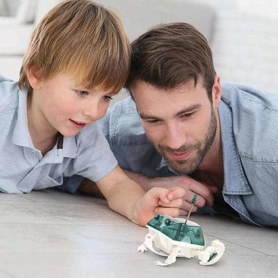 Father and son playing with Bionic Robot Frogzilla STEM science set on the floor
