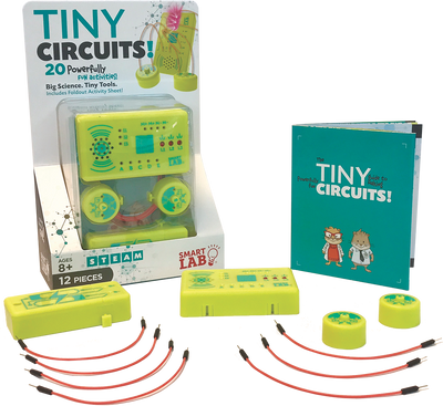 Tiny Circuits mini-microprocessor kit with LEDS, speaker, wires, buttons, and instruction booklet for building electronic projects.