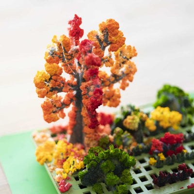 Colorful crystal trees and bushes in the Crystal Chemistry Garden educational science kit for kids