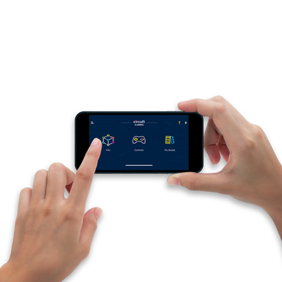Hands holding a smartphone displaying the Circuit Cubes app interface for controlling the Bluetooth Upgrade Kit.