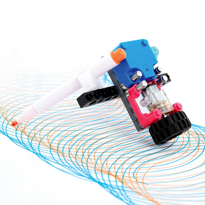 STEM Starter Kit circuit cube with motor and pen drawing colorful spirograph patterns on white background