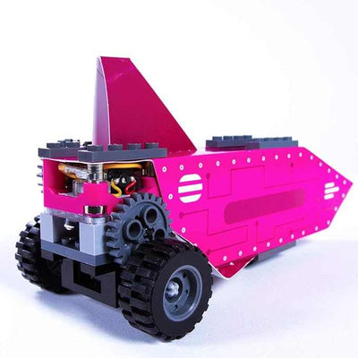 Motorized pink vehicle model built with Gears GO! STEM kit featuring gears and wheels on white background