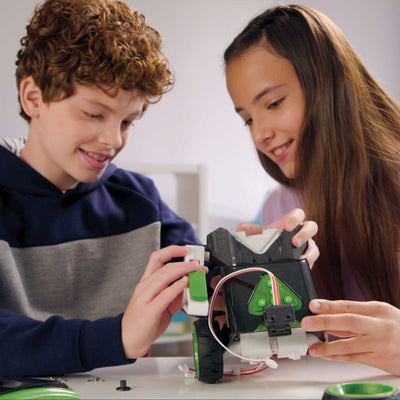 Two children assembling and programming the Robotics Smart Machines Sidekick robot kit at a table