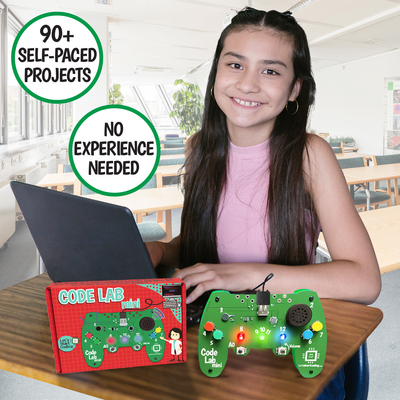 Young girl using a Code Lab Mini coding circuit board shaped like a game controller with laptop and packaging on a desk.