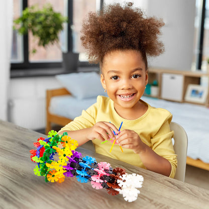 Child playing with colorful PicassoTiles Building Chips construction set on a table indoors