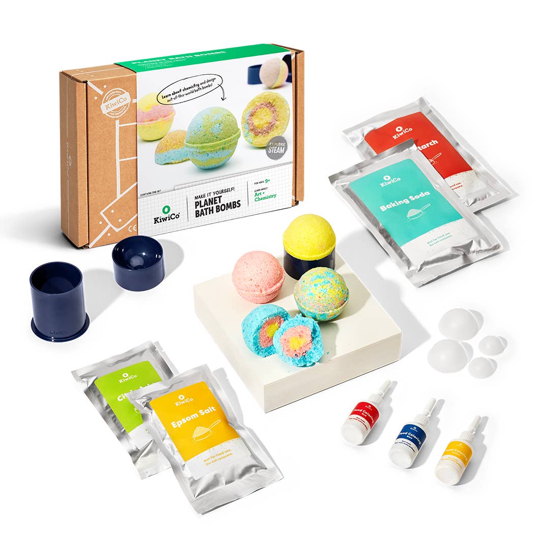 Planet Bath-Bombs Science Kit with colorful planet-shaped bath bombs, baking soda, citric acid, food coloring, molds, gloves, and instruction book for STEM learning.