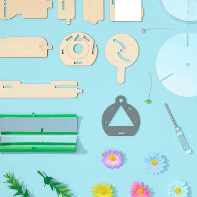 Nature Kaleidoscope Set DIY science kit showing wooden parts, mirror panels, screwdriver, and colorful decorative flowers on a blue background