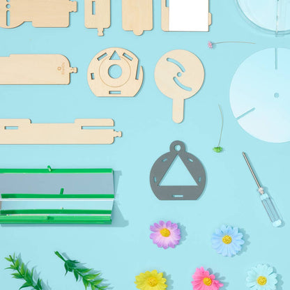 Nature Kaleidoscope Set DIY science kit showing wooden parts, mirror panels, screwdriver, and colorful decorative flowers on a blue background