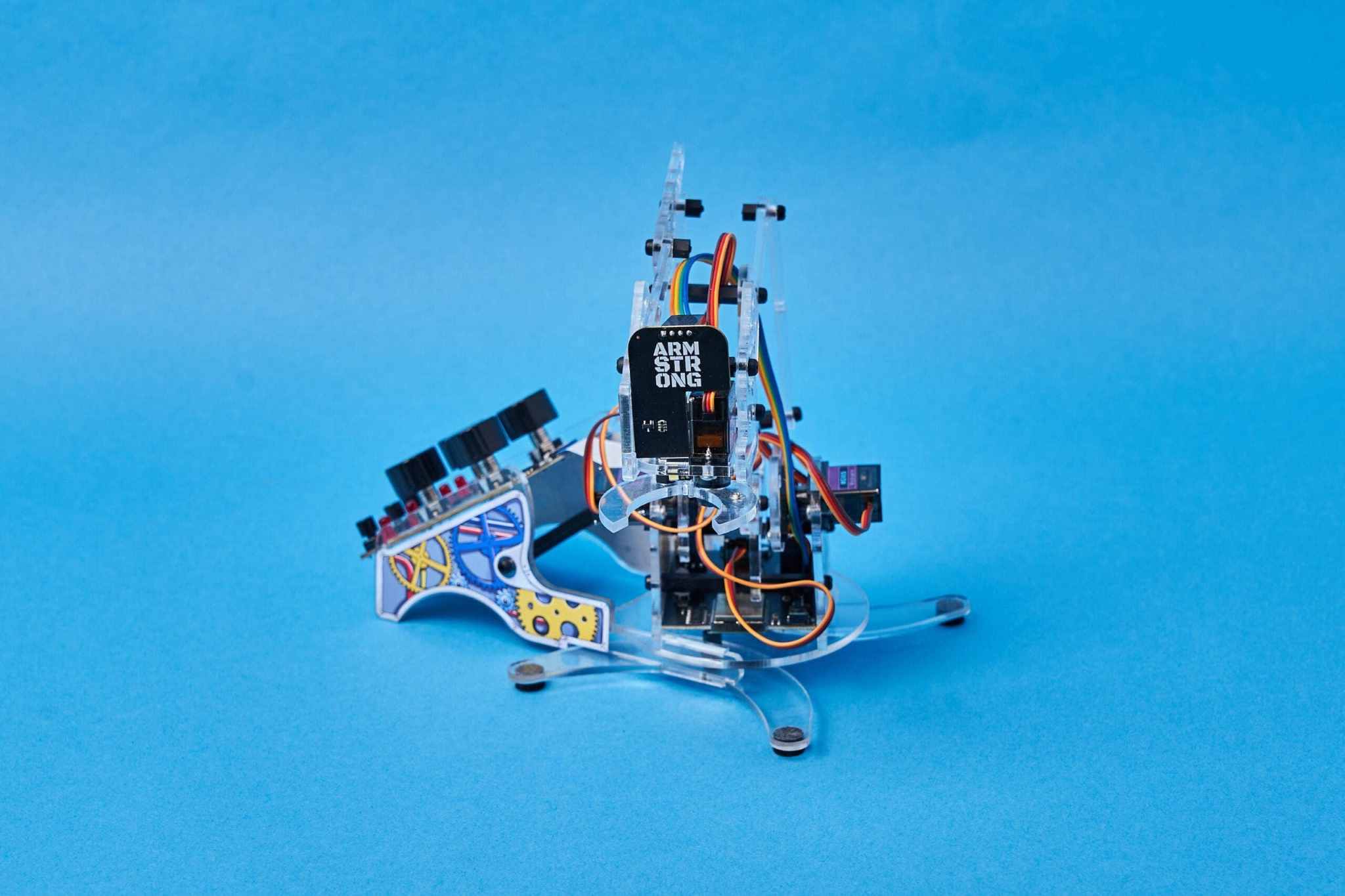 DIY Color Detecting Robotic Arm with coding features on blue background.