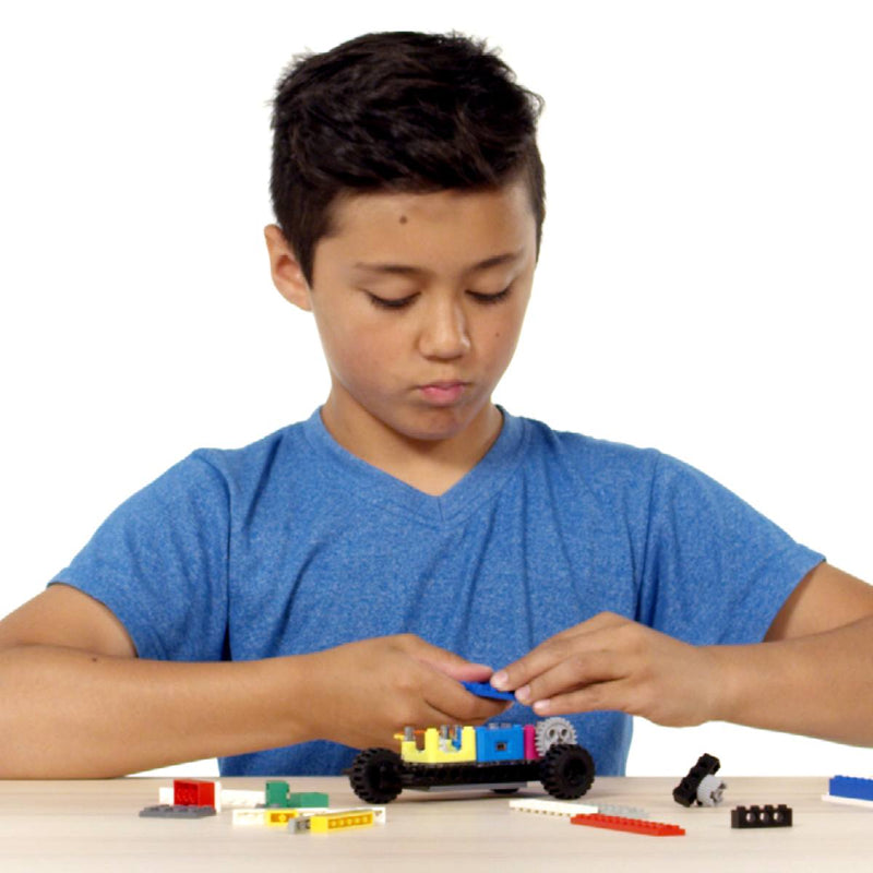 Child building a car with the STEM Starter Kit featuring circuit cubes, wheels, and LEGO-style bricks.